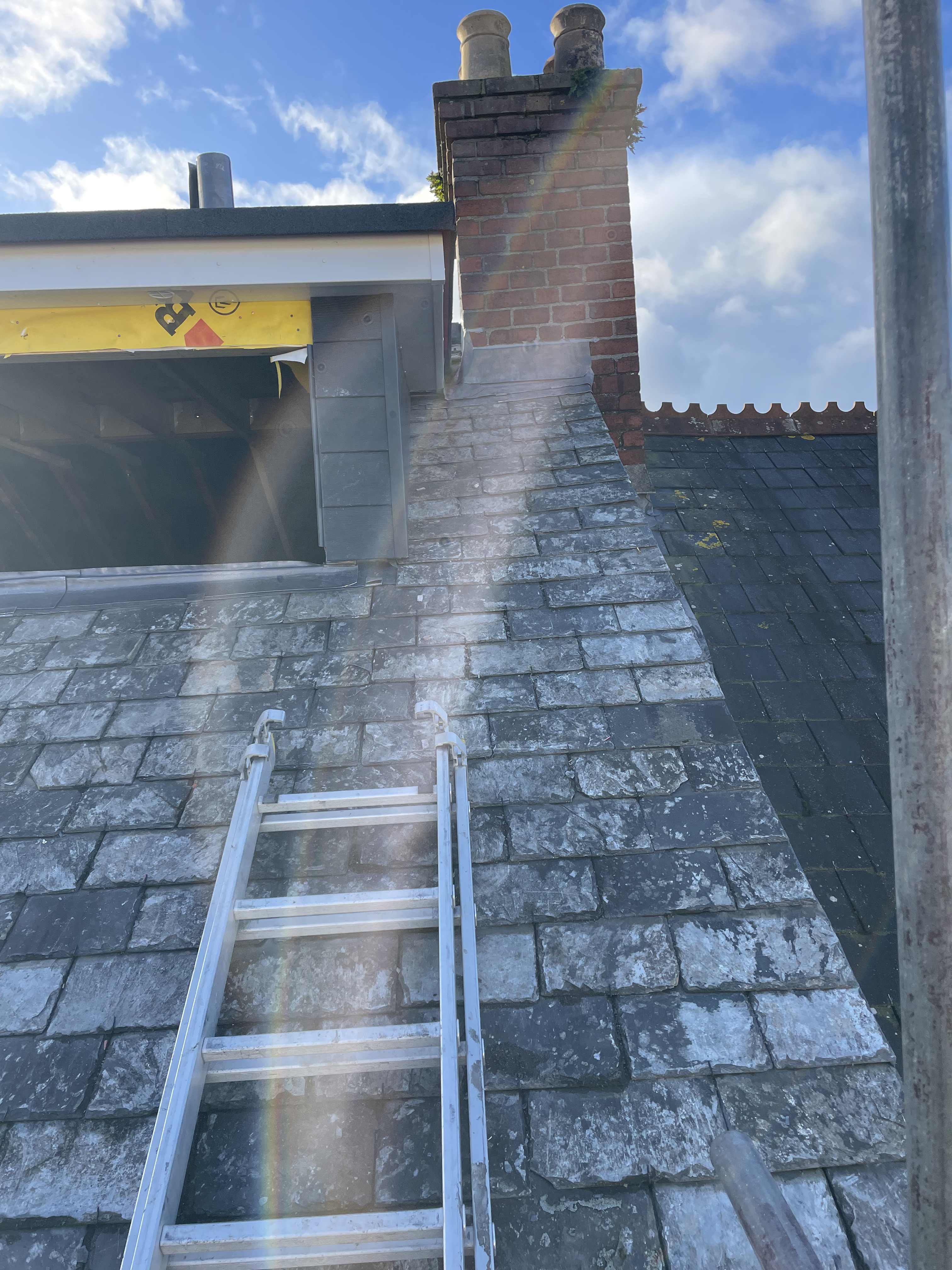 Dormer installation in Totnes featuring composite cladding side cheeks, breathable membrane, and reclaimed Delabole slate pitched roofing by Raven Roofing Services TQ9.