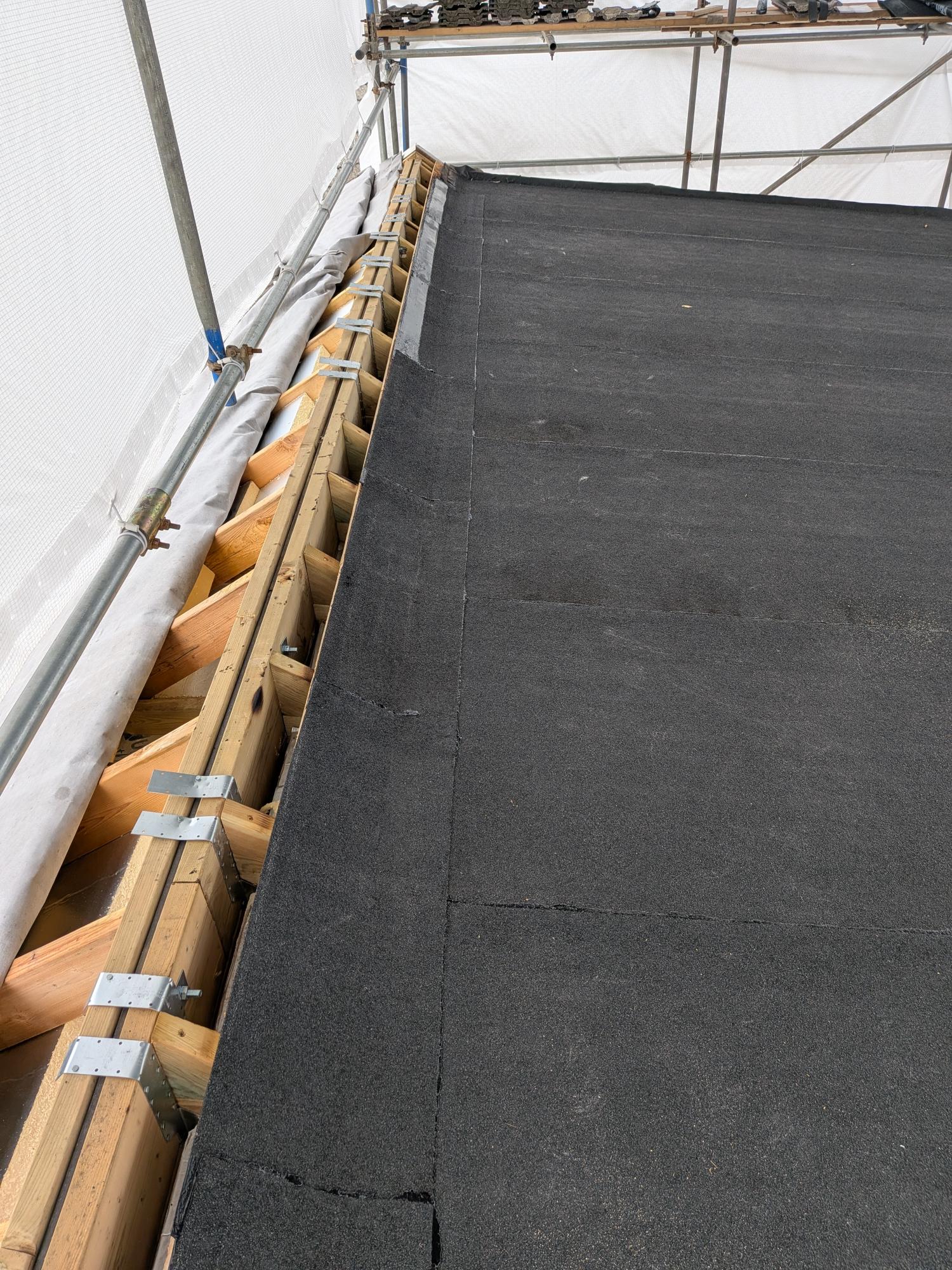 Exposed timber upstands and structural joist preparation prior to final waterproofing on a flat roof extension