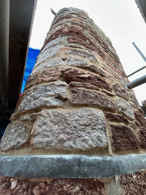 A fully restored chimney stack with fresh repointing and new lead flashing on a house in Brixham.