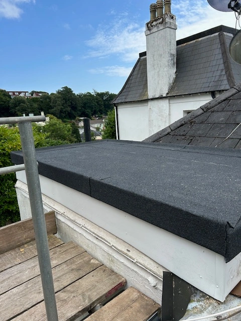 A high-performance torch-on felt roof replacement, perfectly sealed on a garage extension in Torquay.