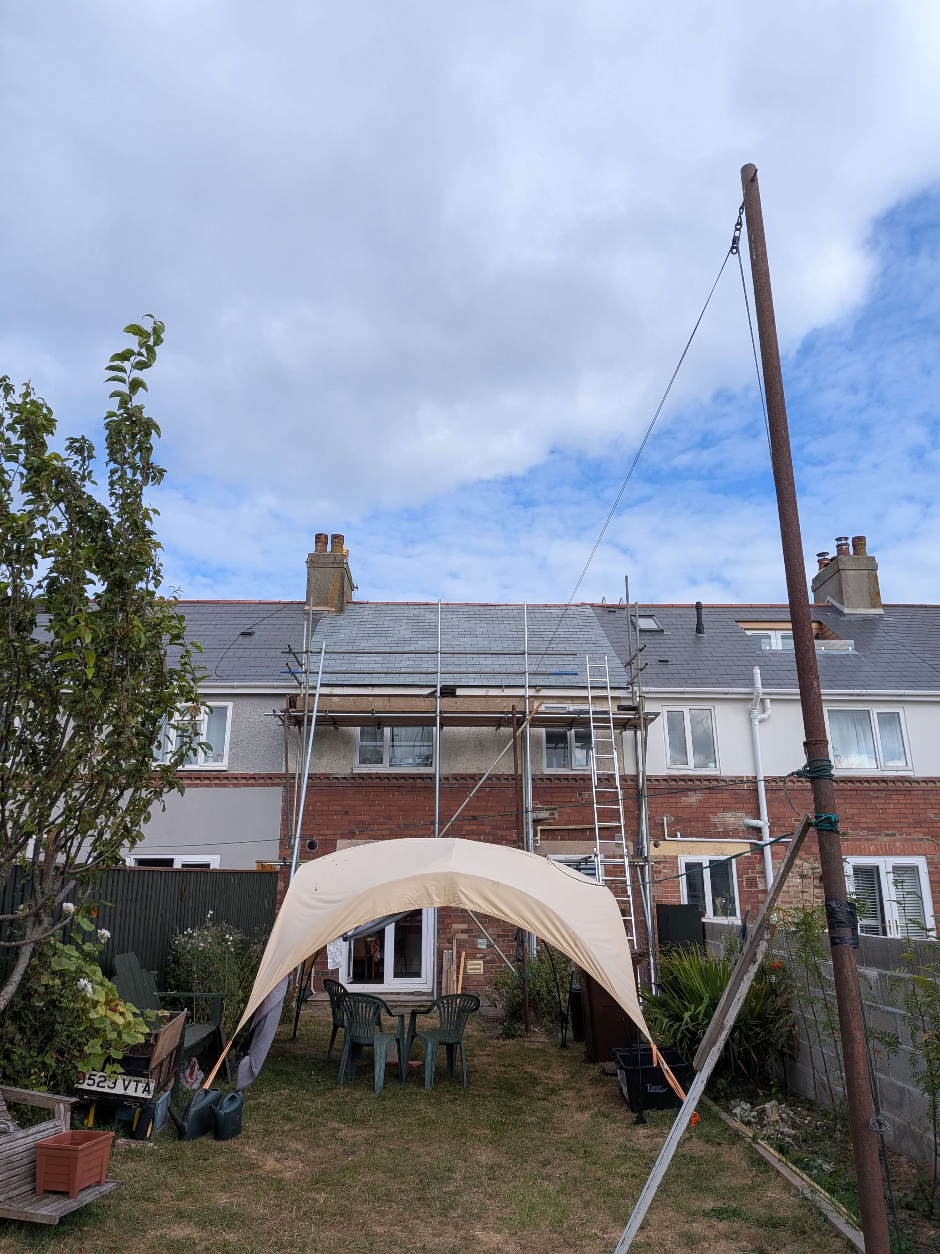 Full scaffolding setup for Brazilian natural slate re-roofing project in Paignton TQ4, Devon, showcasing safe access and site preparation by Raven Roofing Services.