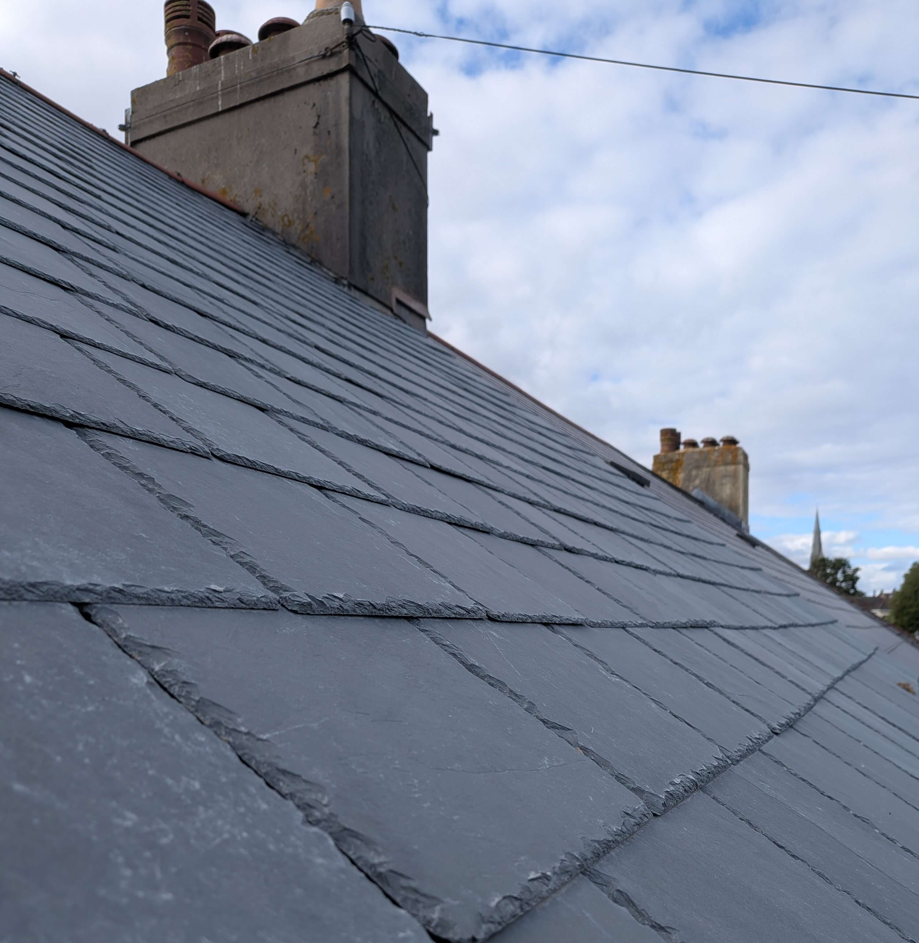 BS 5534 compliant Brazilian slate pitched roof replacement in South Devon, ensuring structural longevity against coastal wind-uplift.