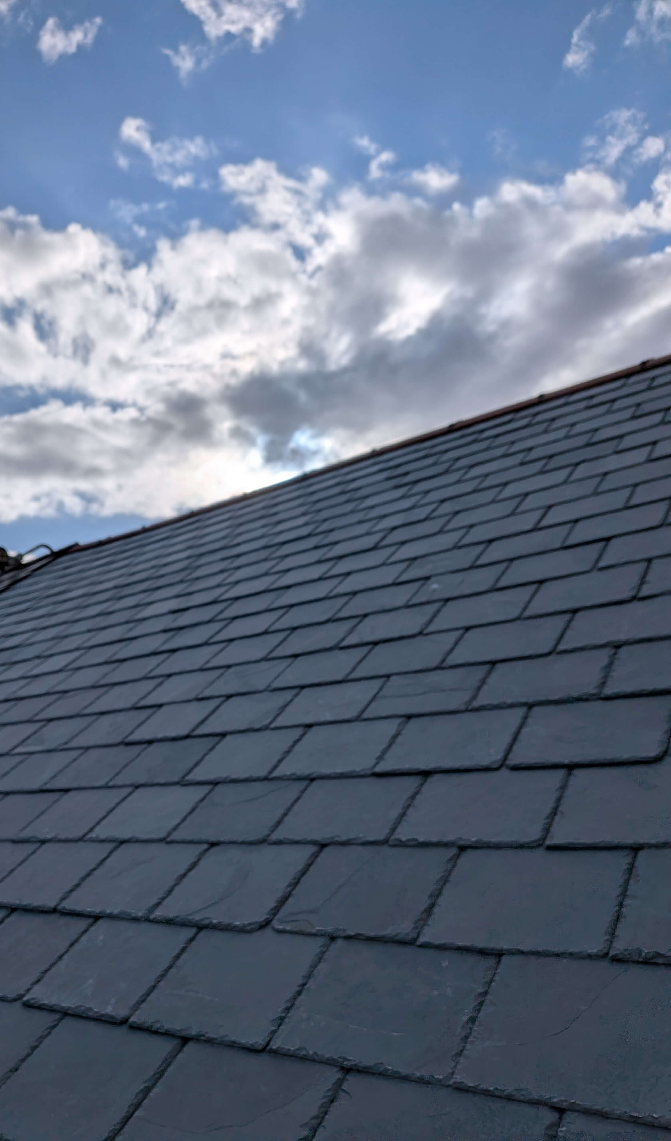 Storm-resistant Brazilian slate roof replacement engineered for maritime climates in Paignton, mitigating historic nail sickness.