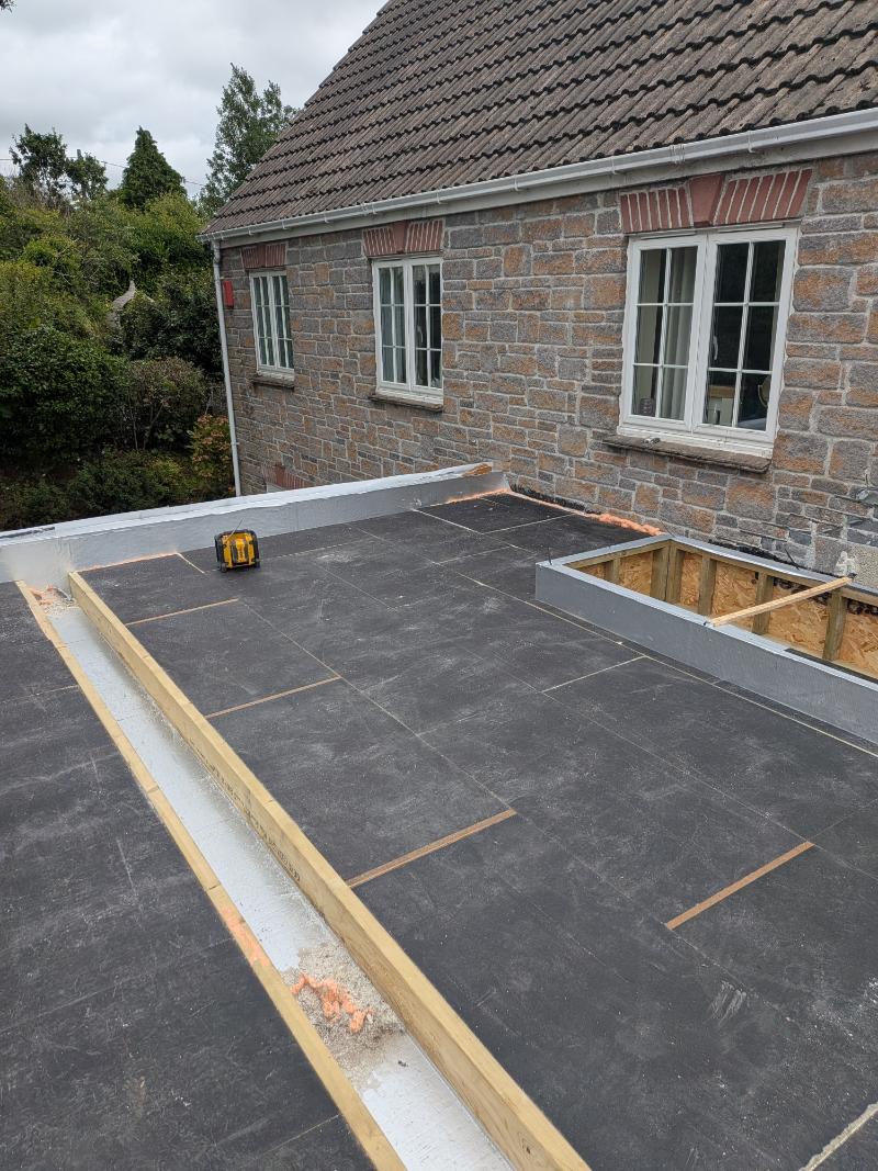 150mm thick rigid PIR insulation board installed across deck terminating into recessed timber hard-edging gutter channel